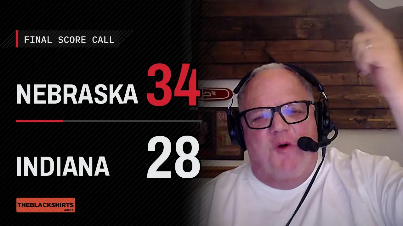 A final score call graphic reading Nebraska 34, Indiana 28, beside Denny Paulsen in a headset pointing up as he makes the pick.